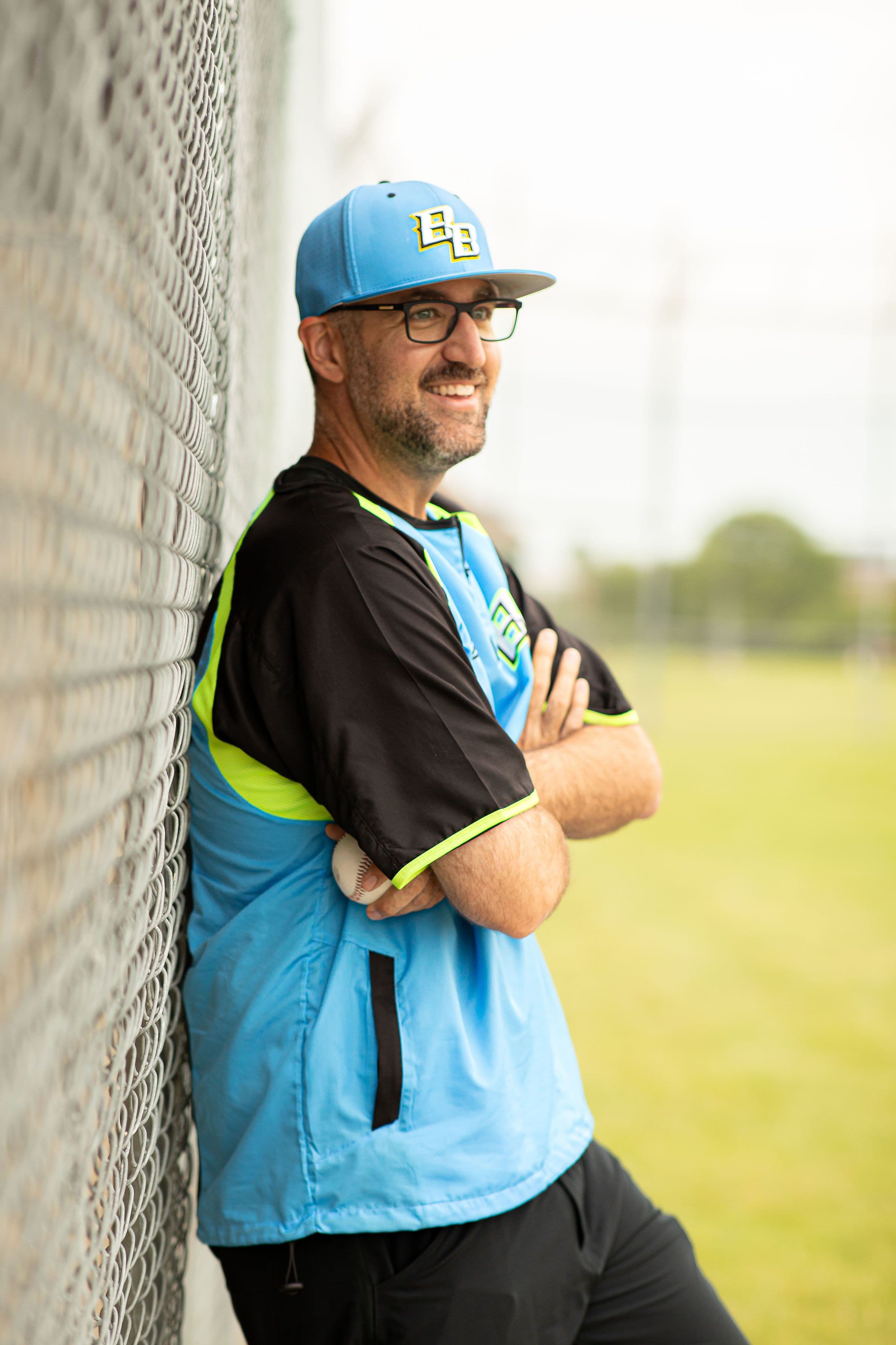 Coach Kyle Richardson walking on the baseball field